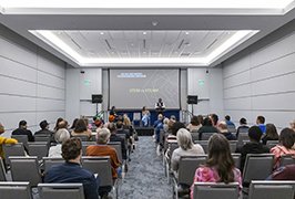  A group of people sit in a lecture hall